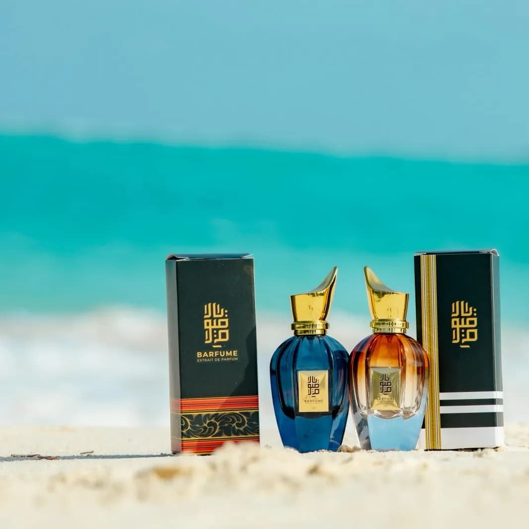 The Barfume gift box and bottles arranged on the sand